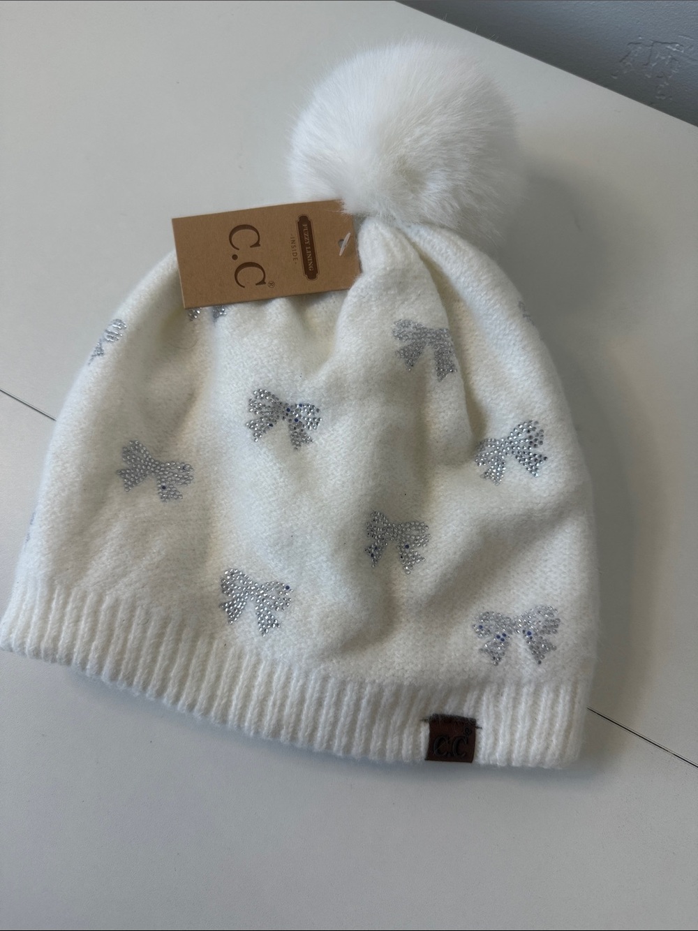 C.C Cream Beanie with Sparkling Silver Bows and Faux Fur Pom